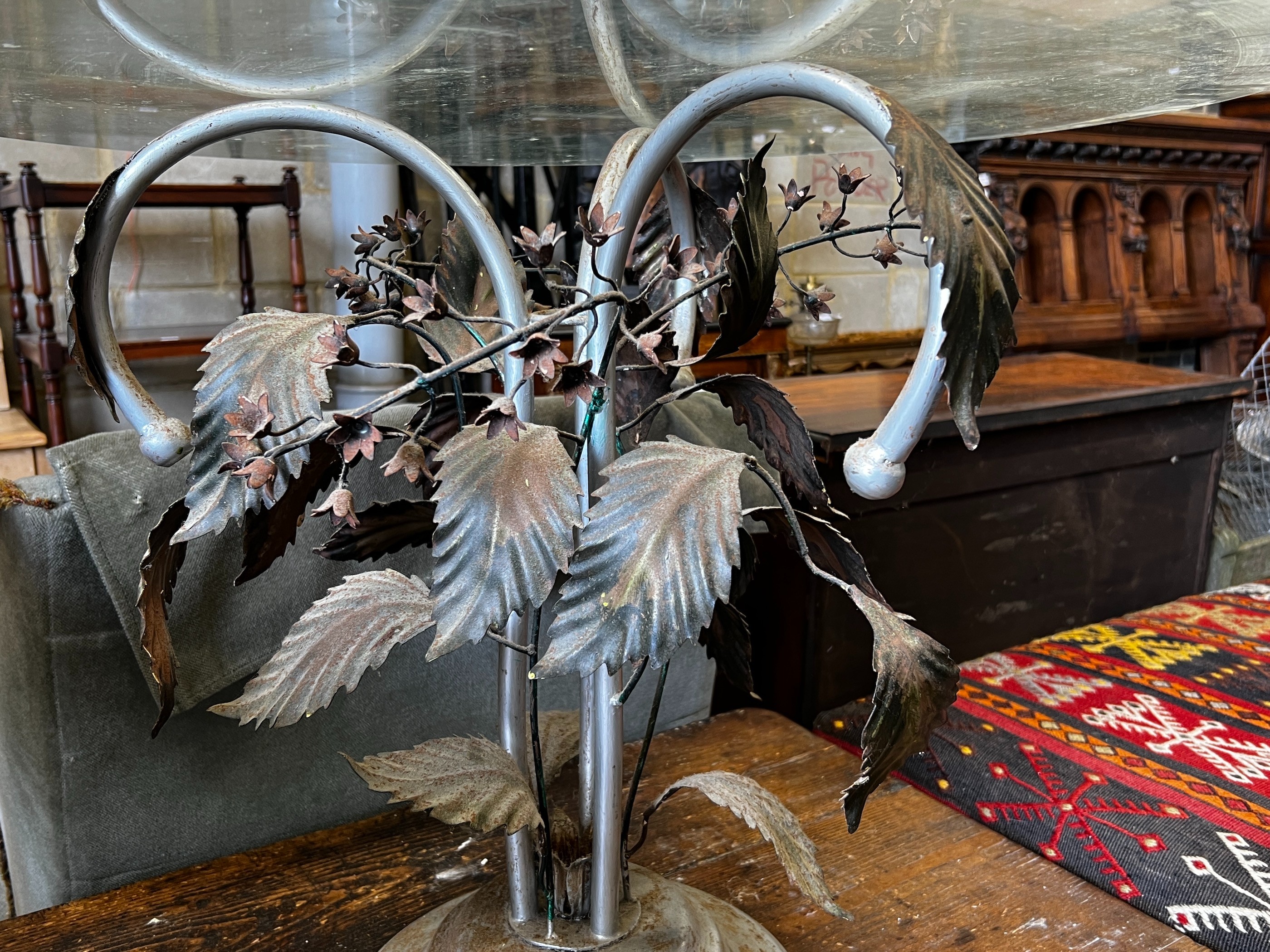 A circular glass topped coffee table on metal underframe, diameter 76cm, height 56cm